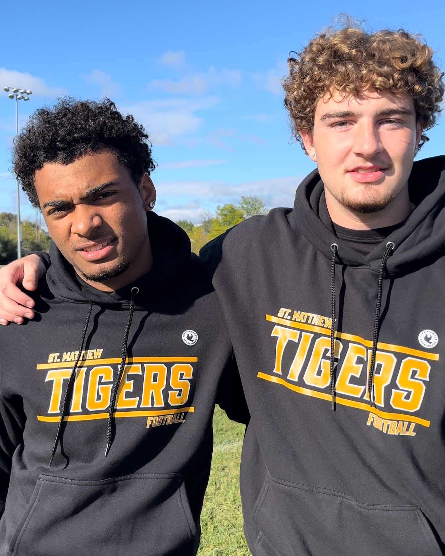 Players in custom Tigers Football hoodies.