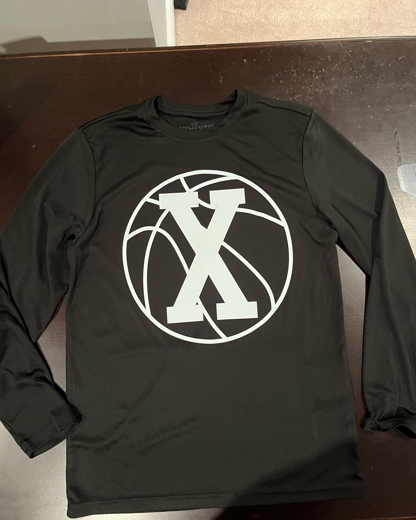 Custom performance long sleeve with oversized crest.