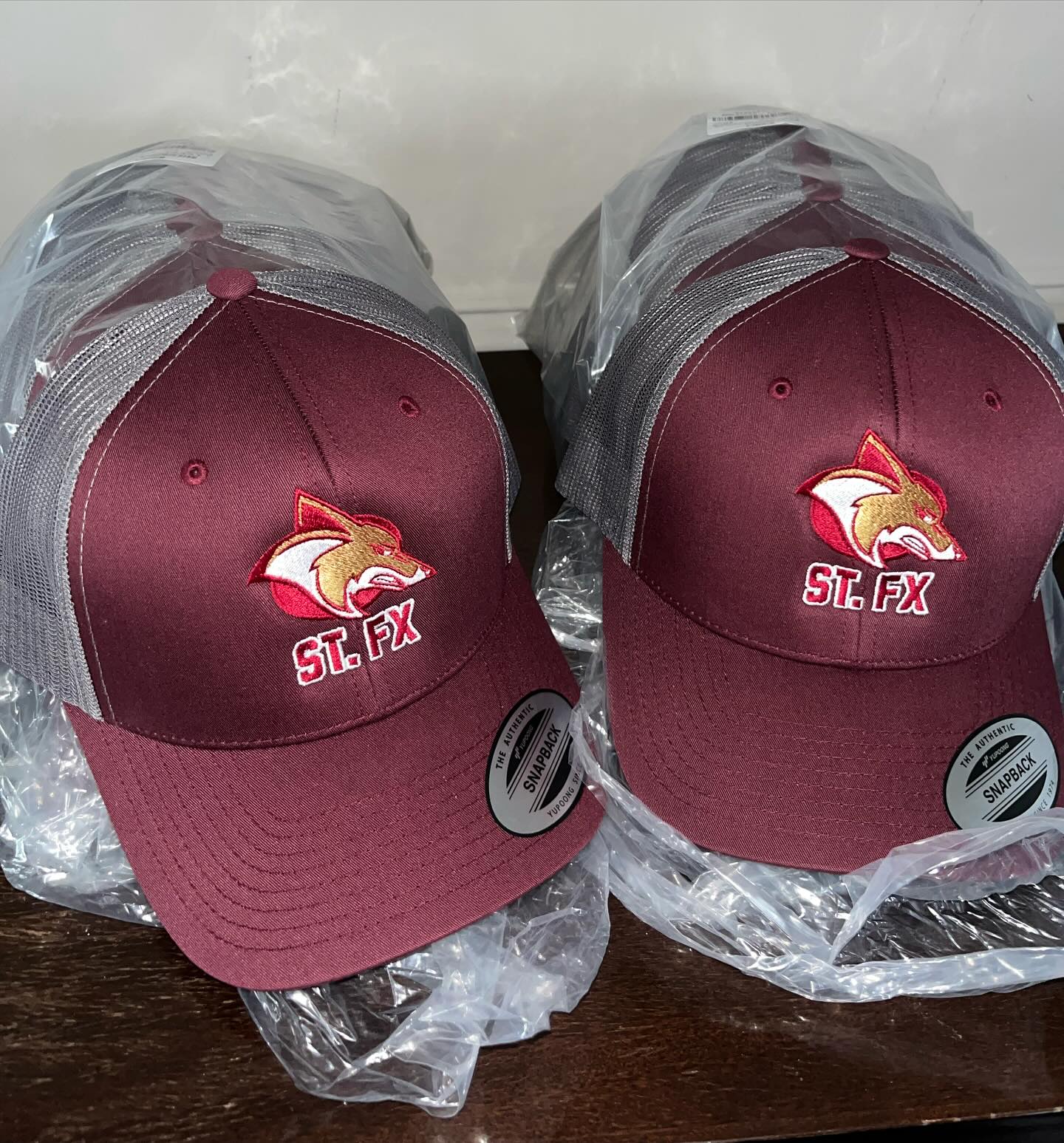 Embroidered snapback run for a school program.