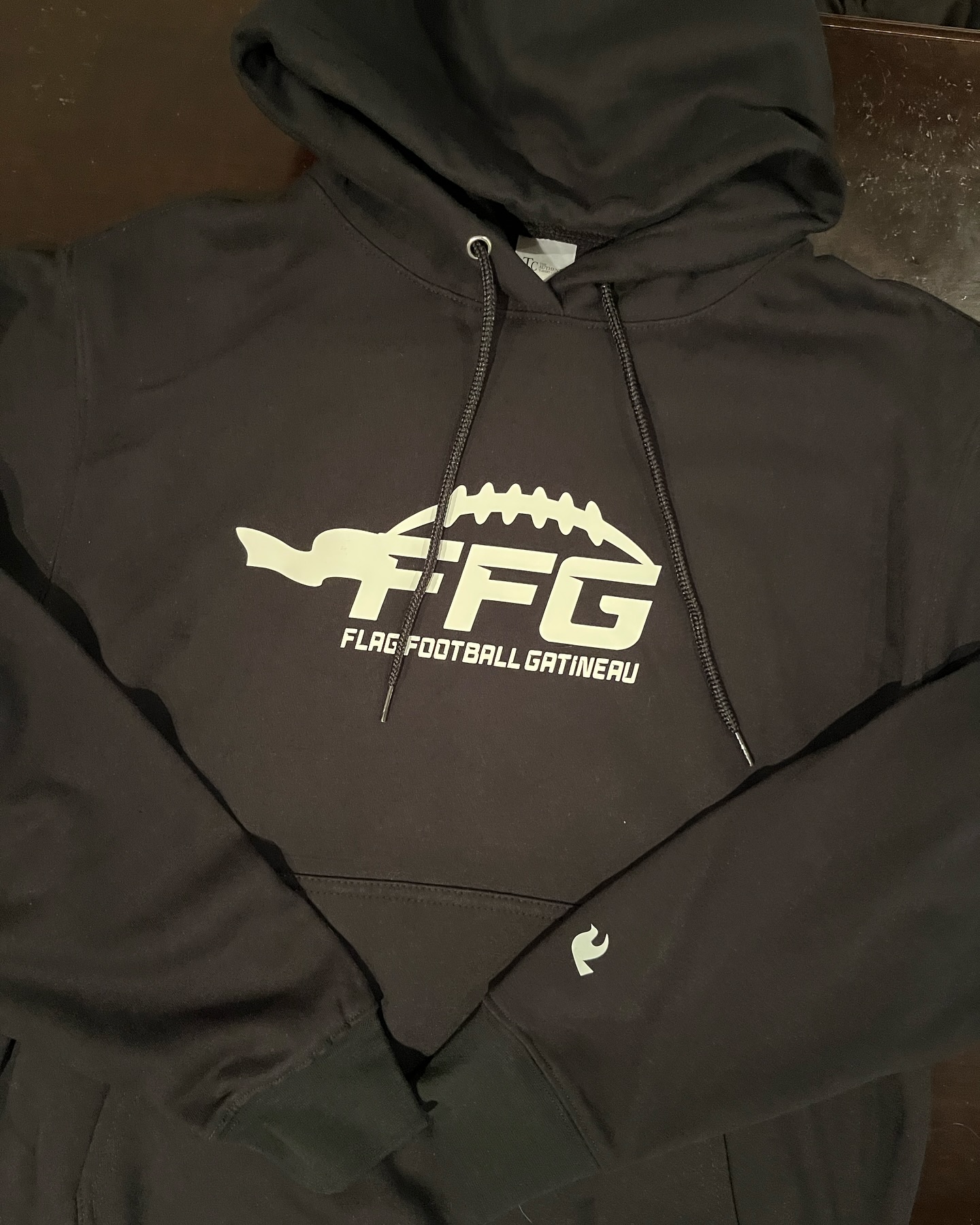 Club hoodie with chest and sleeve branding.