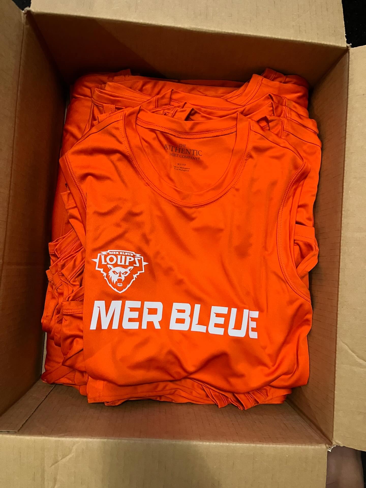 Bulk performance tees boxed and ready to ship.
