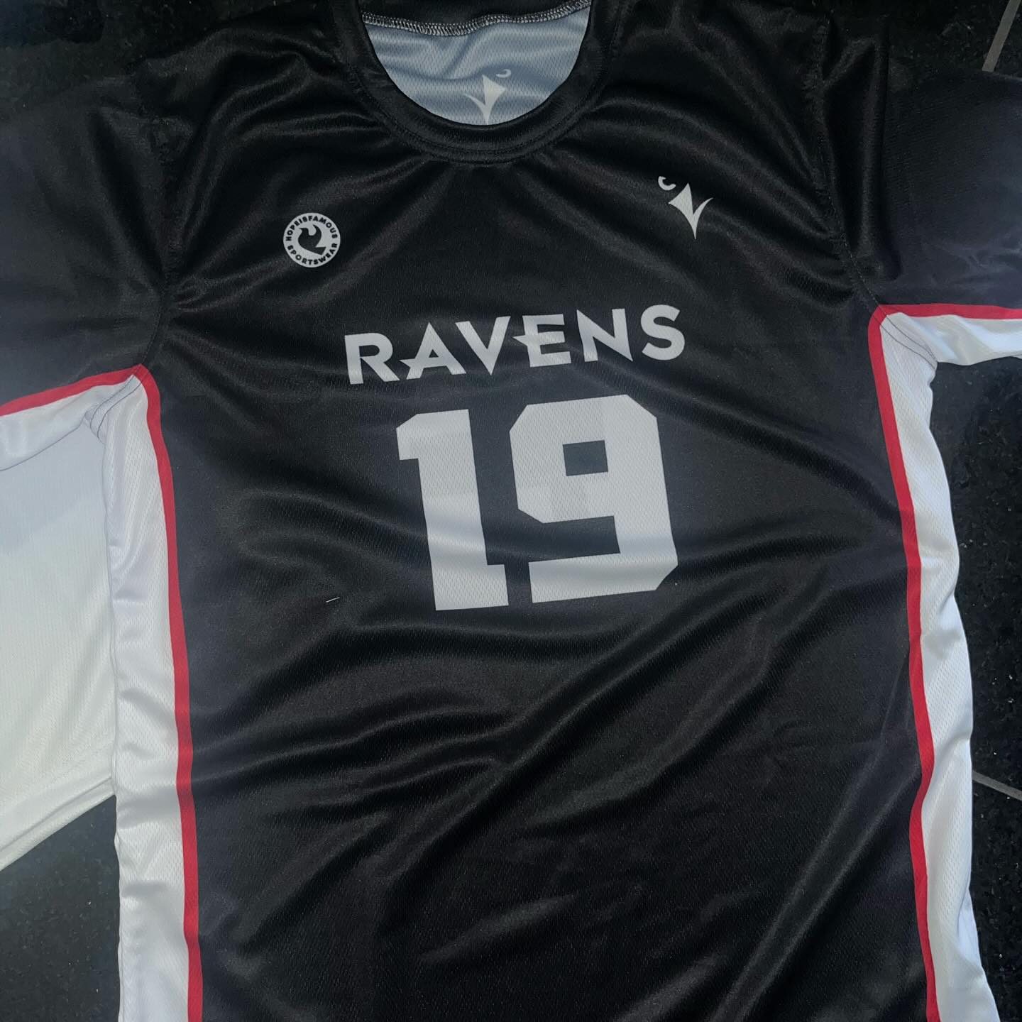 Black and red sublimated jersey with contrast panels.